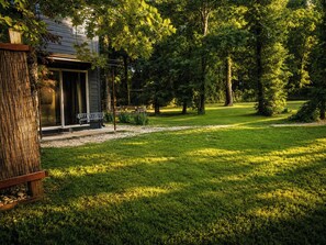 A house with a covered porch, a bench, and a well-maintained lawn. - Spacious 4-bedroom house in peaceful Texoma (Kingston)