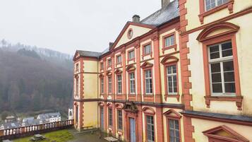 A large, historic building with multiple windows and a courtyard.