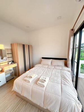 A modern hotel room with a large bed, a desk, and a wardrobe. - 3BR near Old Town & Chillva Market - 8 Guests (Mueang Phuket)