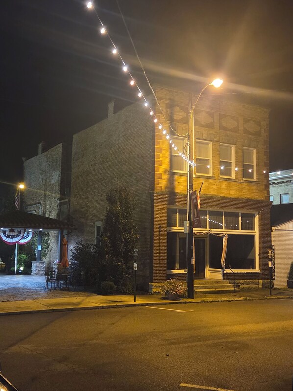 A building with a brick facade, a visible entrance, and a street lamp.