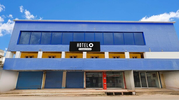 A two-story building with a sign that reads 'HOTEL' and 'Company-Sponsored'. - Hotel O Eluru Railway Station (Eluru)