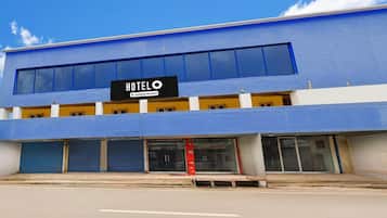 A blue building with a sign that reads 'HOTEL' and 'Company-Sponsored'.