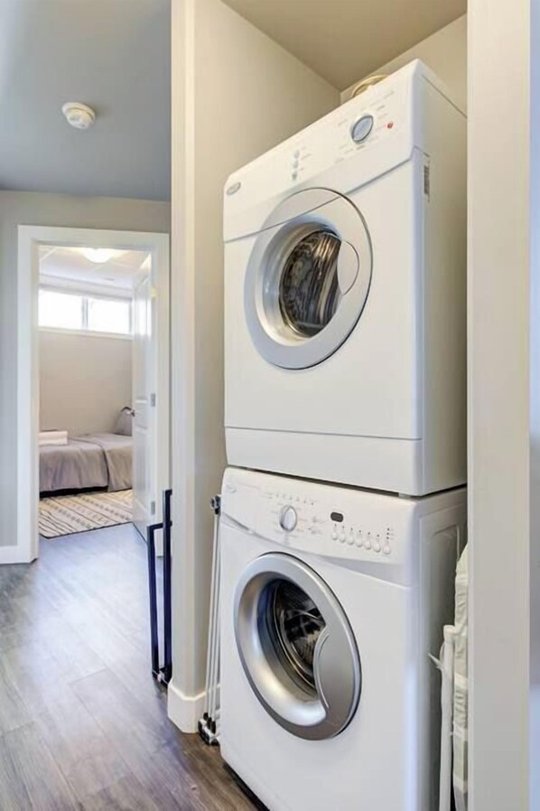 A laundry area with two stacked front-loading washing machines.