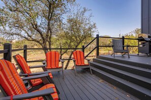 A deck with outdoor seating and a barbecue grill. - Lake Buchanan Bliss | Pool & Spa • Lakefront Beach (Burnet)