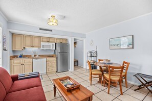 A compact living space with a kitchenette, dining area, and a sofa. - The Pelican Nest-Perfect North Myrtle Beach Getaway (MYRTLE BEACH)