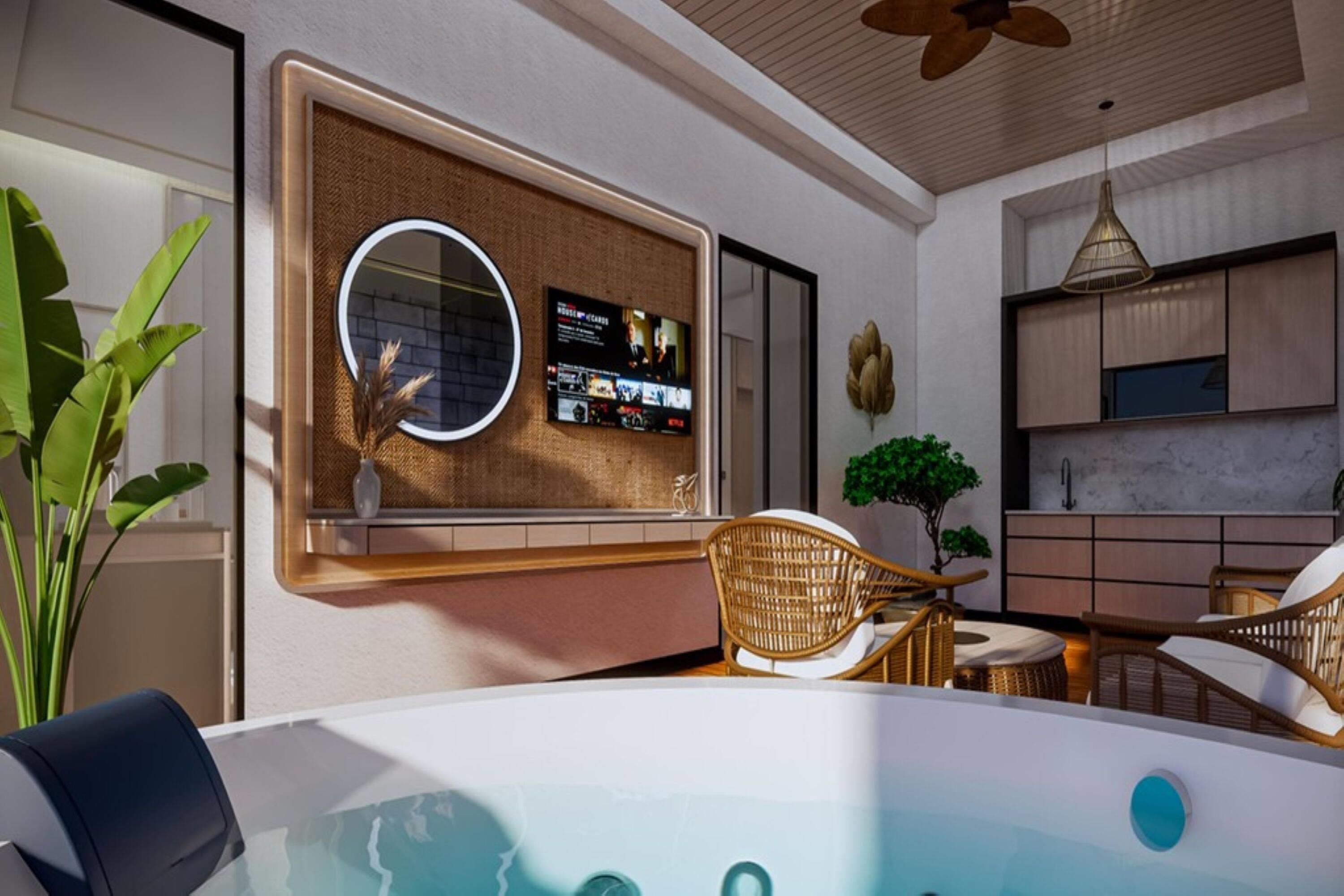 A modern bathroom with a bathtub, a mirror, and a wall-mounted TV.