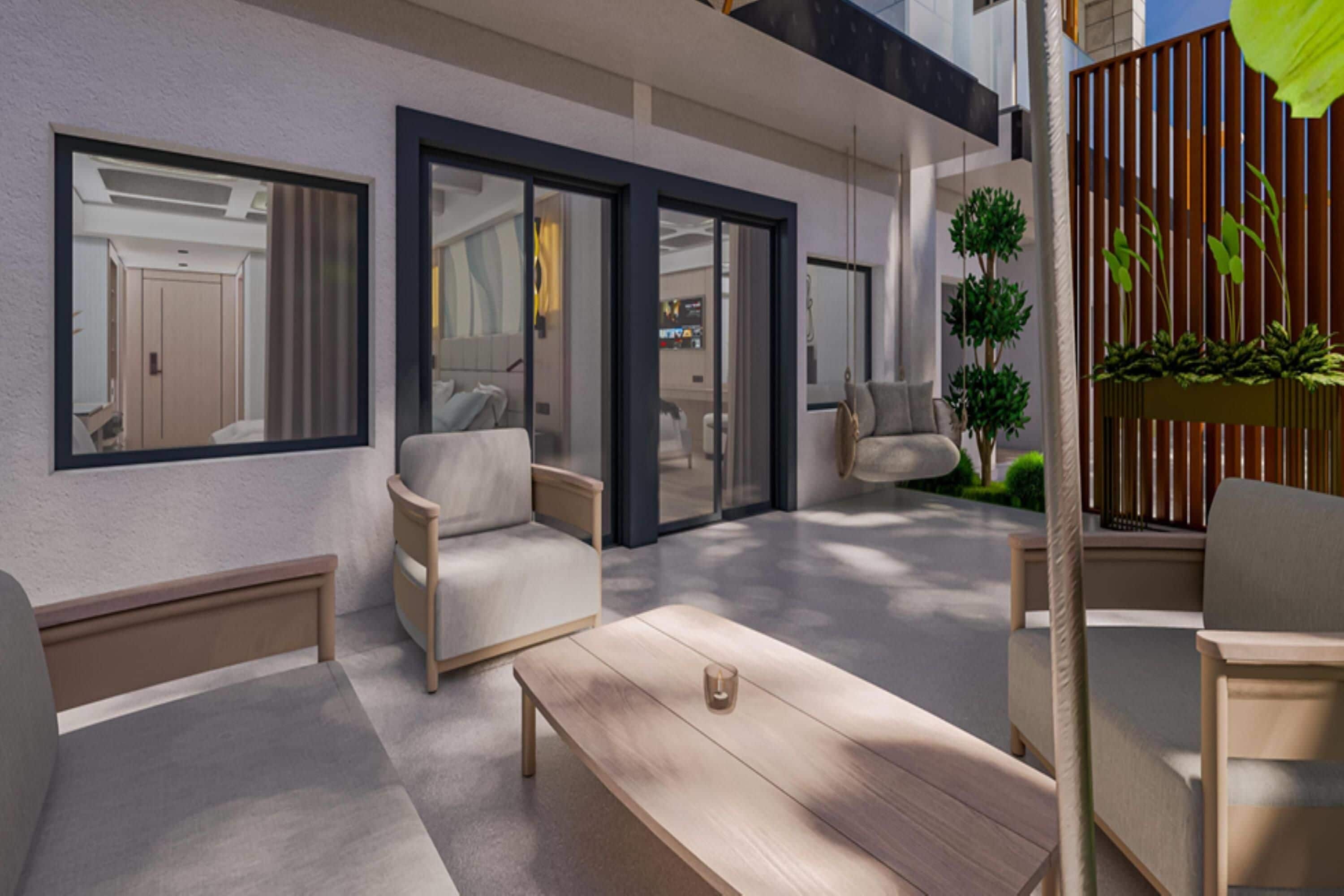 A modern outdoor living area with a sofa, chairs, a table, and a potted plant.