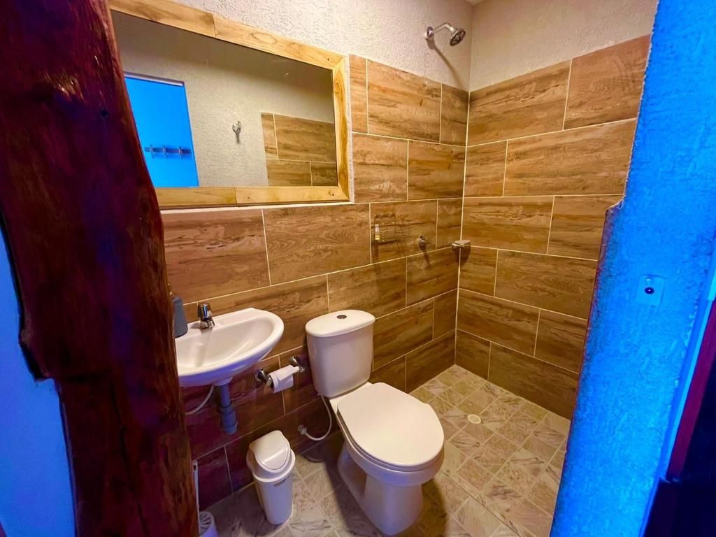 A bathroom with a sink, toilet, and shower.