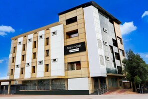 A multi-story building with a sign reading 'Townhouse Company-Service.'