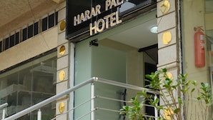 The exterior of Harar Palace Hotel with a signboard, a staircase, and a fire extinguisher. - Harar Palace Hotel (Harar)