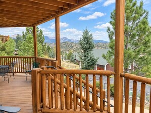 A wooden deck with a railing, overlooking a mountainous landscape. - Emerald Mountain 28C | Couples Retreat at Mary’s Lake (Estes Park)