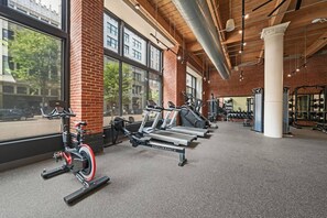 A gym with treadmills, stationary bikes, and weight machines.