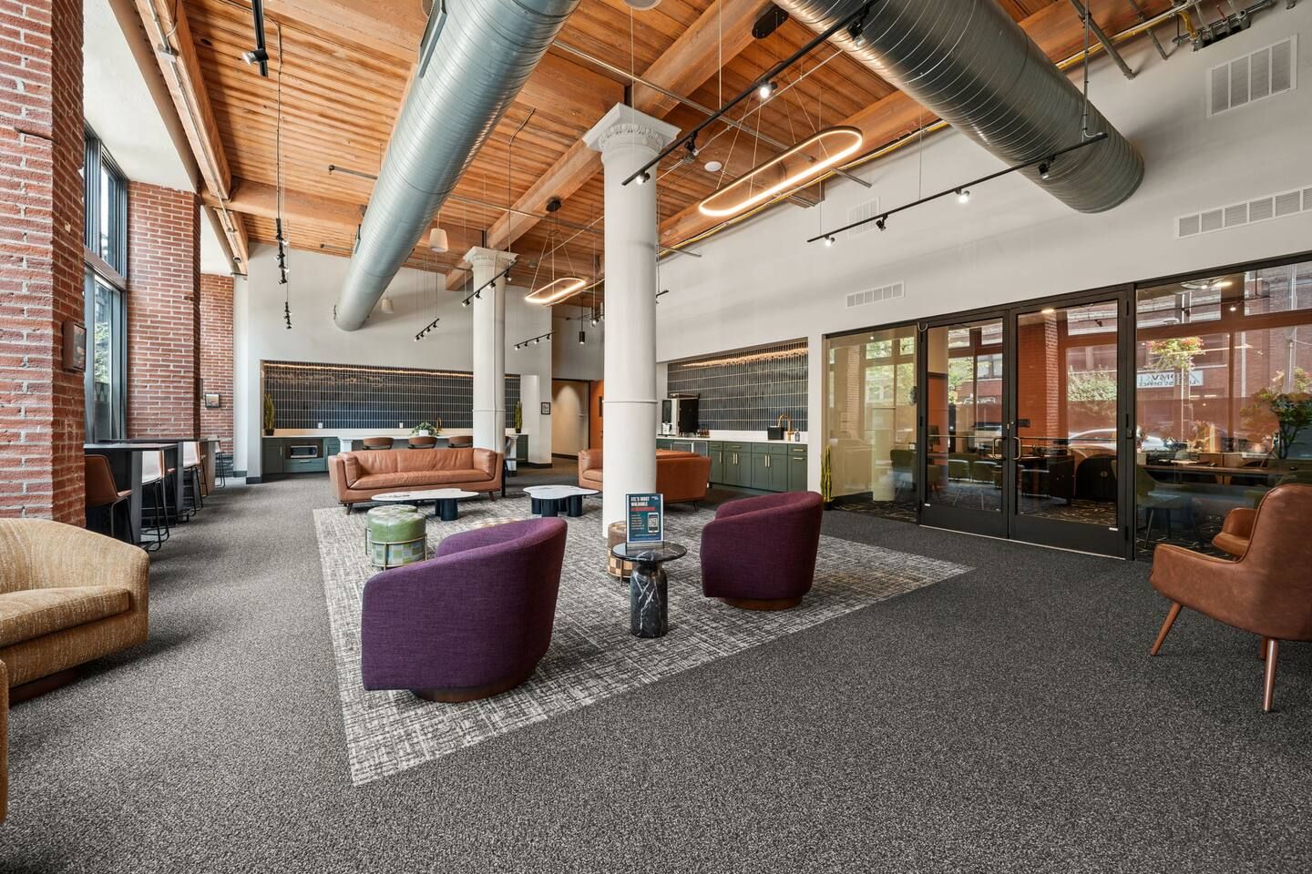 A spacious lobby with seating areas, a coffee table, and a fireplace.