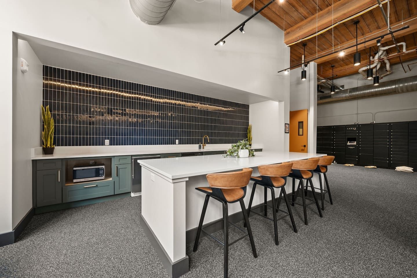 A modern kitchen with a white island, bar stools, and a backsplash with a grid pattern.