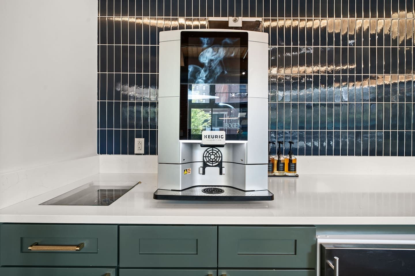 A modern kitchen with a built-in coffee machine, a window with a view, and a countertop with a sink.