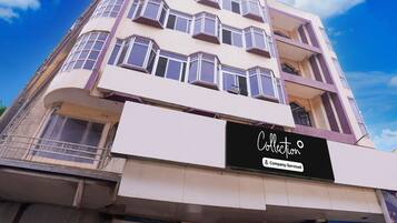 A multi-story building with a sign that reads 'Collection Company-Serviced.'