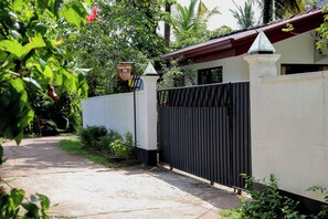 A gated entrance to a property with a sign indicating it is a Nature Beat Villa.