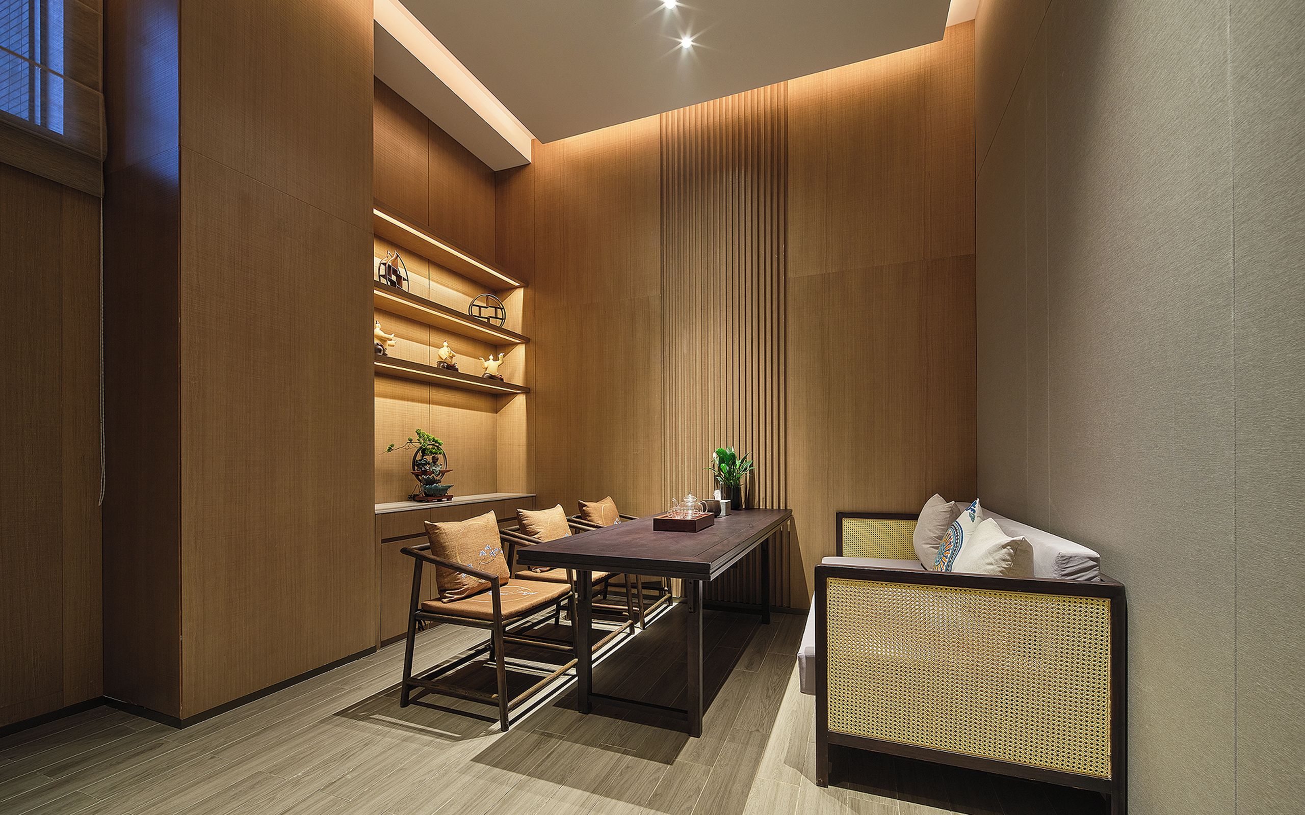 A modern interior with a dining area, seating, and built-in shelving.