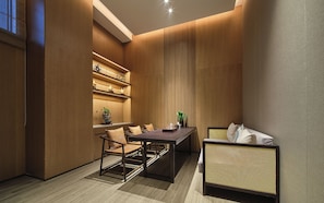 A modern interior with a dining area, seating, and built-in shelving.