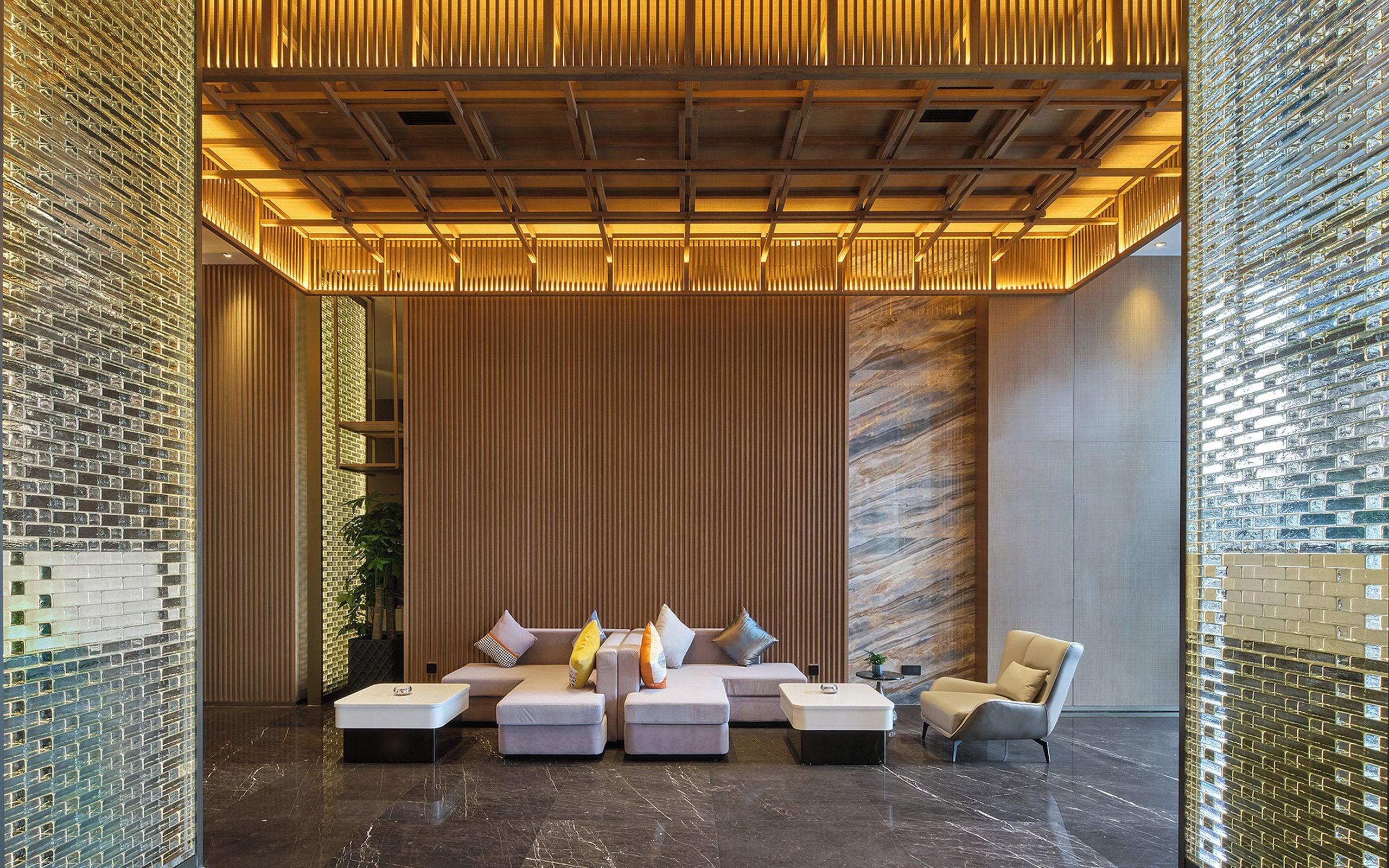 A modern lounge area with a seating arrangement and a wooden ceiling structure.