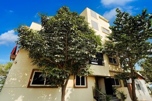 A multi-story building with a flat roof, several windows, and a staircase leading to the entrance. - Super Collection O Kammasandra Gate (Bengaluru)