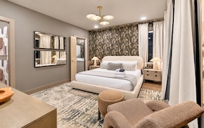 A modern hotel room with a large bed, two bedside tables, a desk, and a seating area. - Pool, Hot Tub, Sauna, 11 Beds, Rooftop Kitchen (Nashville)