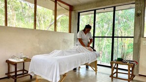 A room with a bed, a window, and a small table with items on it. - Hotel El Encanto Chichen Itzá (Holcá)