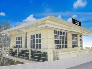 A hotel building with a flat roof, large windows, and a sign indicating it is a hotel. - Super Hotel O Ghoom Aps Homestay (Darjeeling)