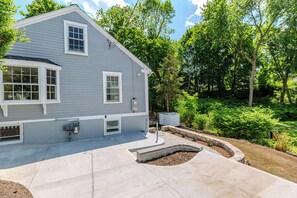 A residential house with a garage, a driveway, and a landscaped garden area.