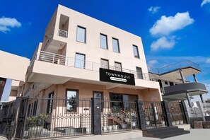A multi-story building with a sign indicating it is a serviced company townhouse.
