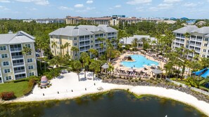 A resort with a central pool, multiple buildings, and a beach area. -  After the thrill of theme parks, you’ll enjoy endless at Sheraton Vistana (Orlando)