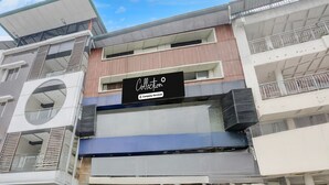 A multi-story building with a storefront labeled 'Collection Company-Serviced.' - Collection O Jaigaon Near Bhutan Gate (Alipurduar)