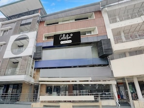 A multi-story building with a storefront labeled 'Collection Company-Serviced.' - Collection O Jaigaon Near Bhutan Gate (Alipurduar)
