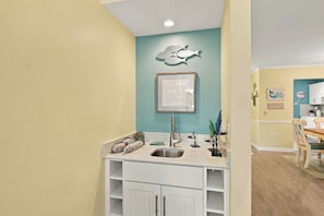 A kitchen with a countertop, sink, and cabinets. - Renovated Shipyard Villa, Bike to the Beach! (Hilton Head Island)