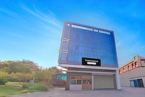 A modern building with a sign reading 'TOWNHOUSE' and a company service label.
