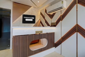 A reception area with a sign for 'Townhouse Oak' and a 'Reception' sign, indicating a company-serviced hotel.