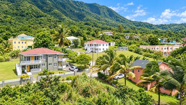 A residential area with houses surrounded by lush greenery and hills. - Cedar Grove 4BR Hillview Retreat (Ogees)