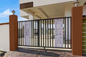 A gated entrance with a decorative metal gate and a small porch area. - Hotel O Ring Road Nagpur (Nagpur)