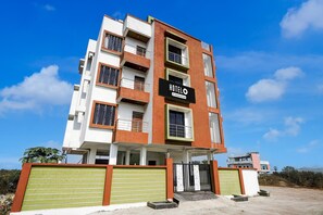 A multi-story hotel with a prominent 'HOTEL' sign, balconies, and a gated entrance. - Hotel O Ring Road Nagpur (Nagpur)