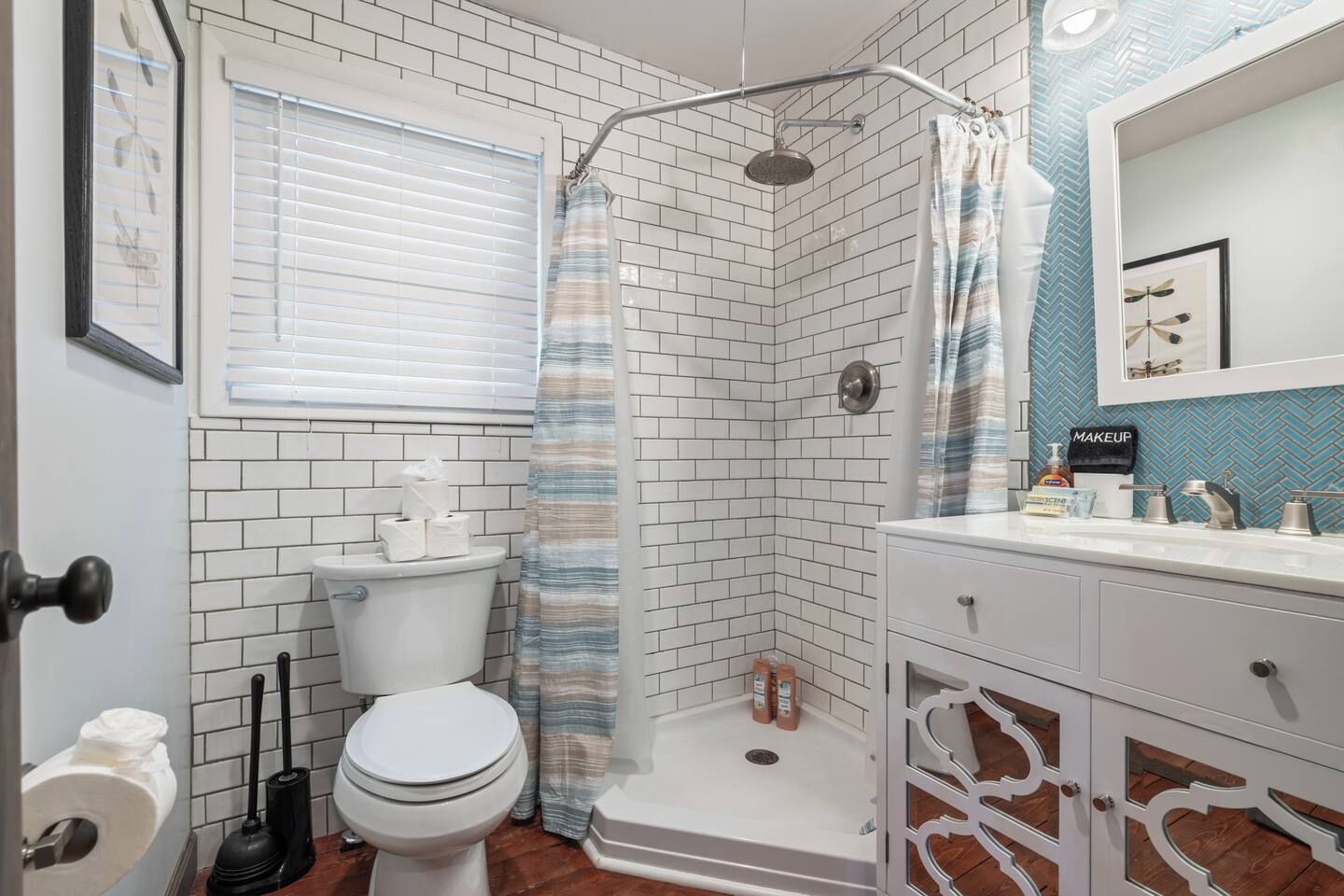 A bathroom with a shower, toilet, and sink.