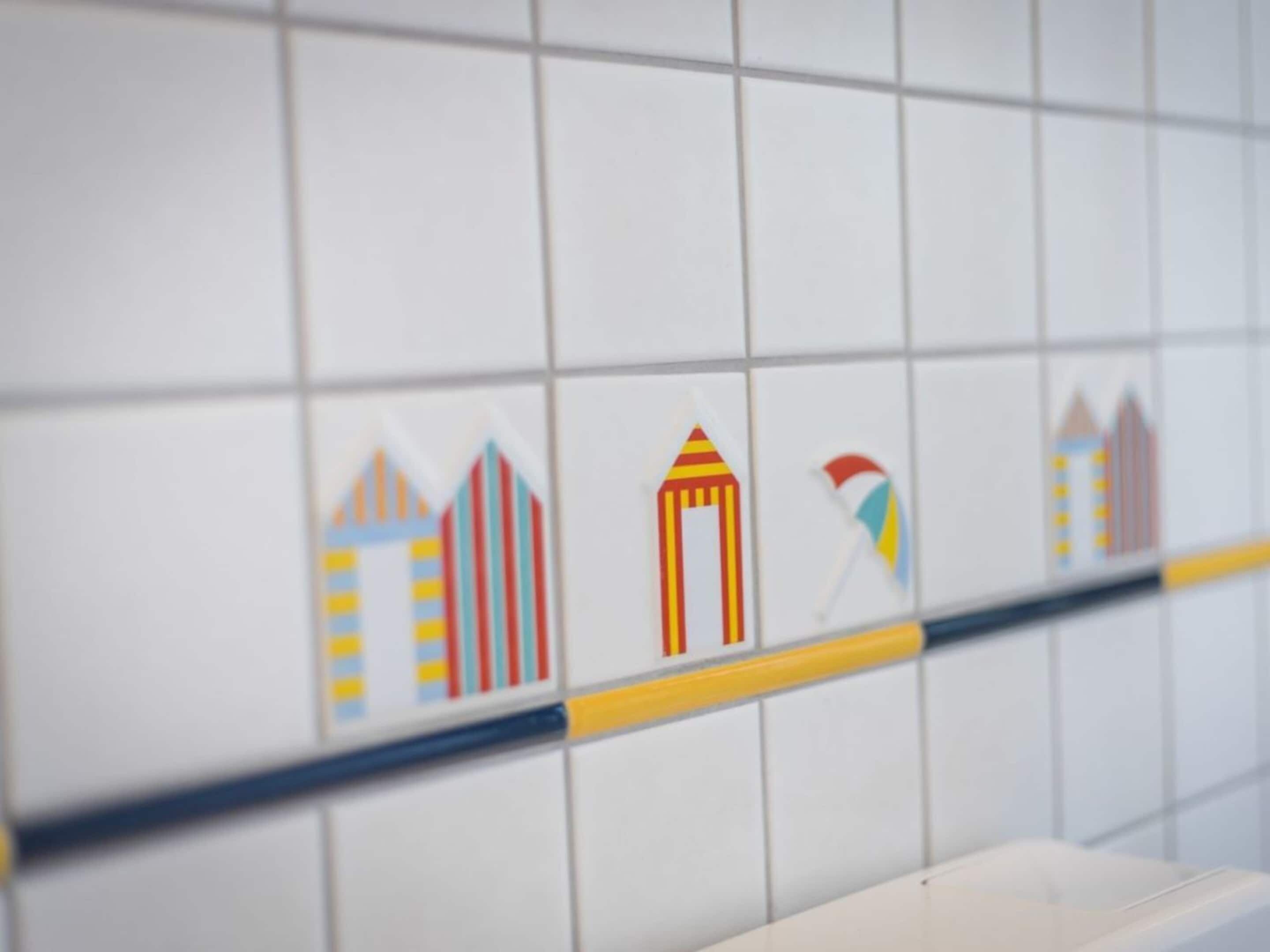 A tiled wall with a row of stylized building icons.