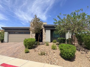 A modern house with a garage, stone facade, and landscaped garden. - Relax, unwind and enjoy Lake Las Vegas! 
6 month bookings only (Henderson)
