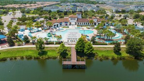 A resort with a central pool, a dock, and a surrounding landscaped area. - 2472 Toy Barn Slide Bed & Game Room! Private Pool (Kissimmee)
