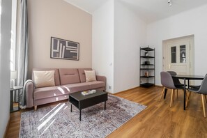 A modern living room with a sofa, coffee table, and a bookshelf. - Blueground | New Town, view, nr Vltava River (PRG-125) (Prague)