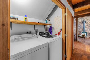 A laundry area with a washing machine, an iron, and a drying rack. - Lakewood Escape - 3BR Retreat (South Lake Tahoe)