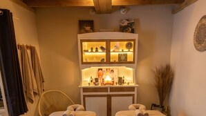 A room with two beds, a wooden ceiling, a cabinet with decorative items, and a wall-mounted light fixture. - Suite with a private hot tub (Pierrelatte)