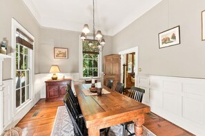 A dining room with a wooden table, chairs, a chandelier, and a view of the outdoors. - Vintage Charm, Backyard, WiFi, Near Dtwn Decatur (Decatur)