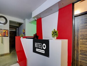 A hotel reception desk with a sign indicating it is company-serviced. - Classic With Balcony The Cloud inn Hotel Grand (Ghaziabad)