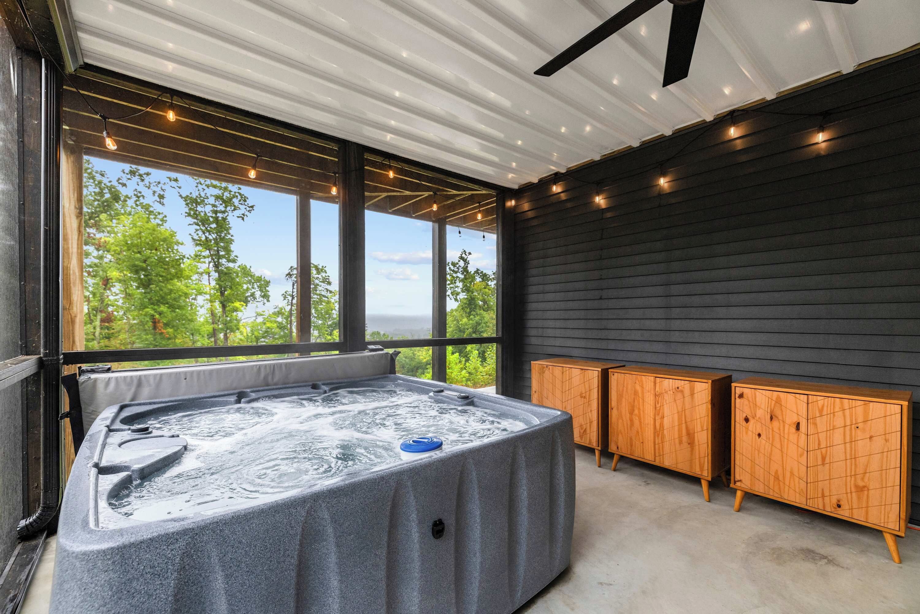 A hot tub area with a view of trees and a clear sky.
