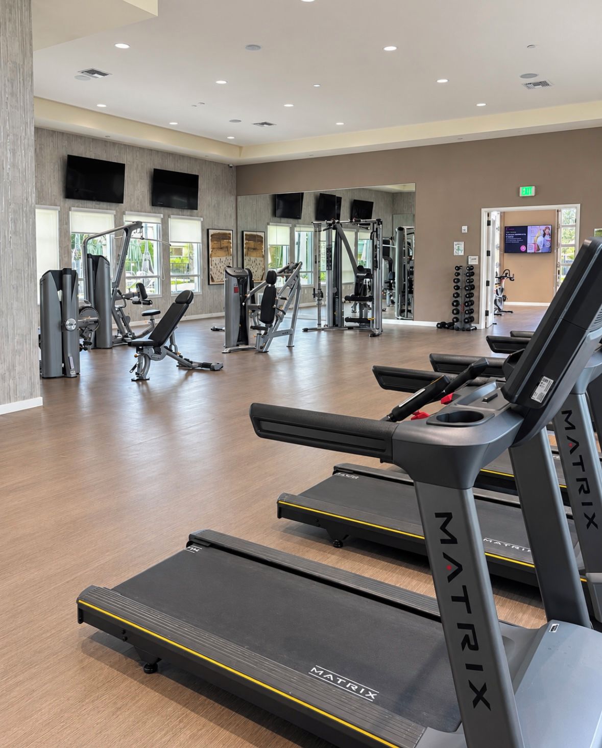 A gym with treadmills, weight machines, and exercise equipment.